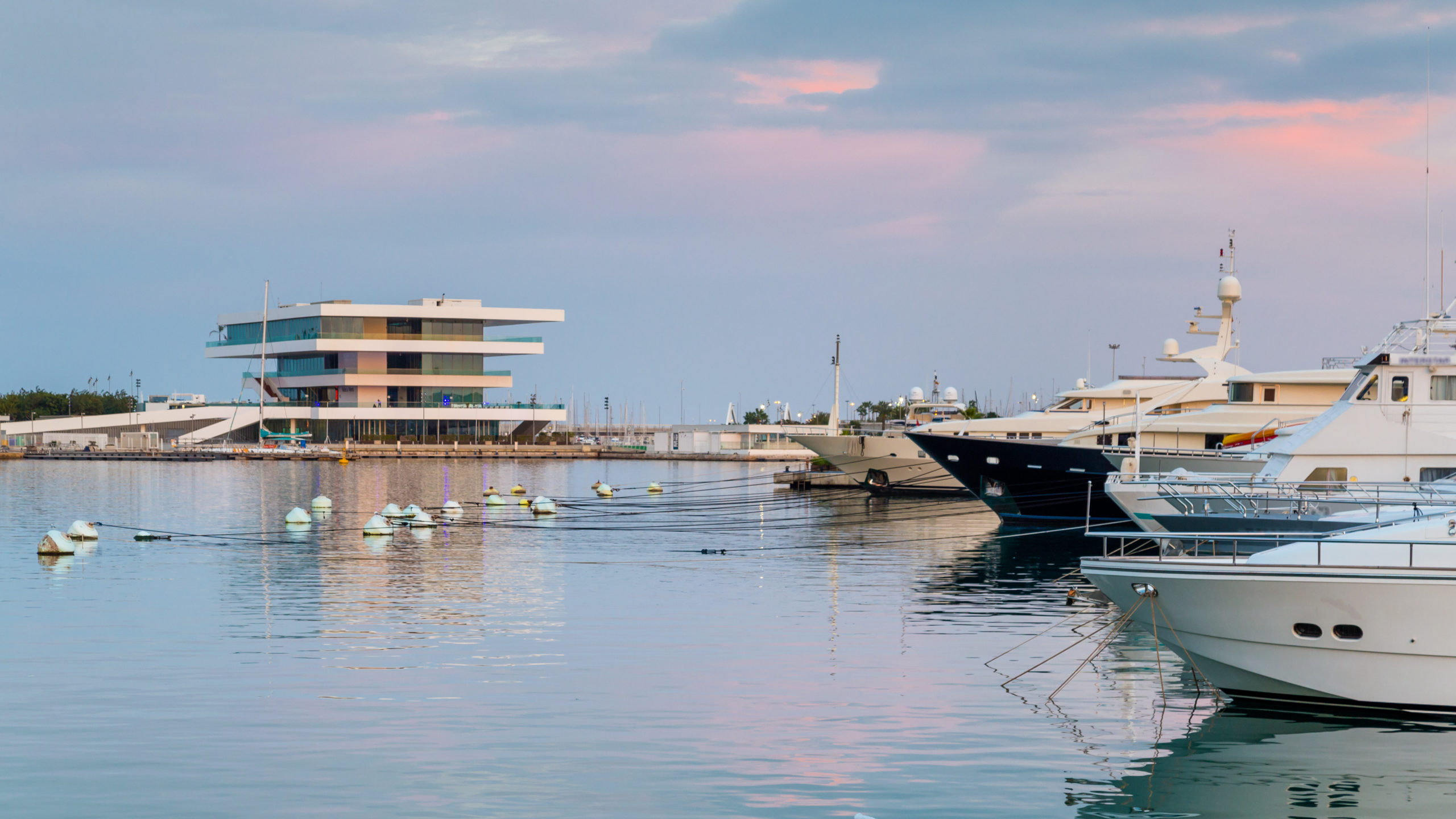 The harbor of  Valencia in Spain with  during sunset with America's Cup Building (Veles e Vents) in the background